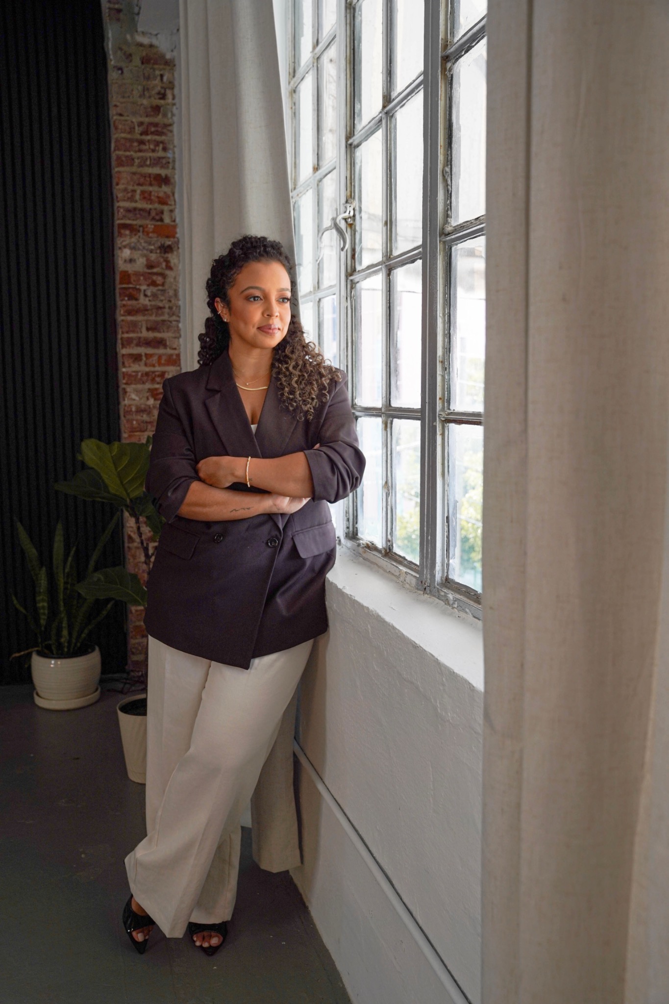 Pamela Rosario by a studio window